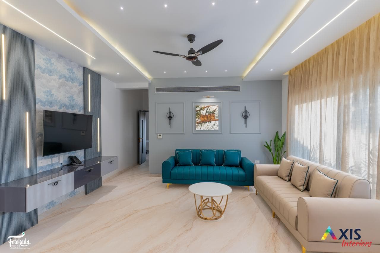 Spacious family lounge with teal sofa and marble flooring