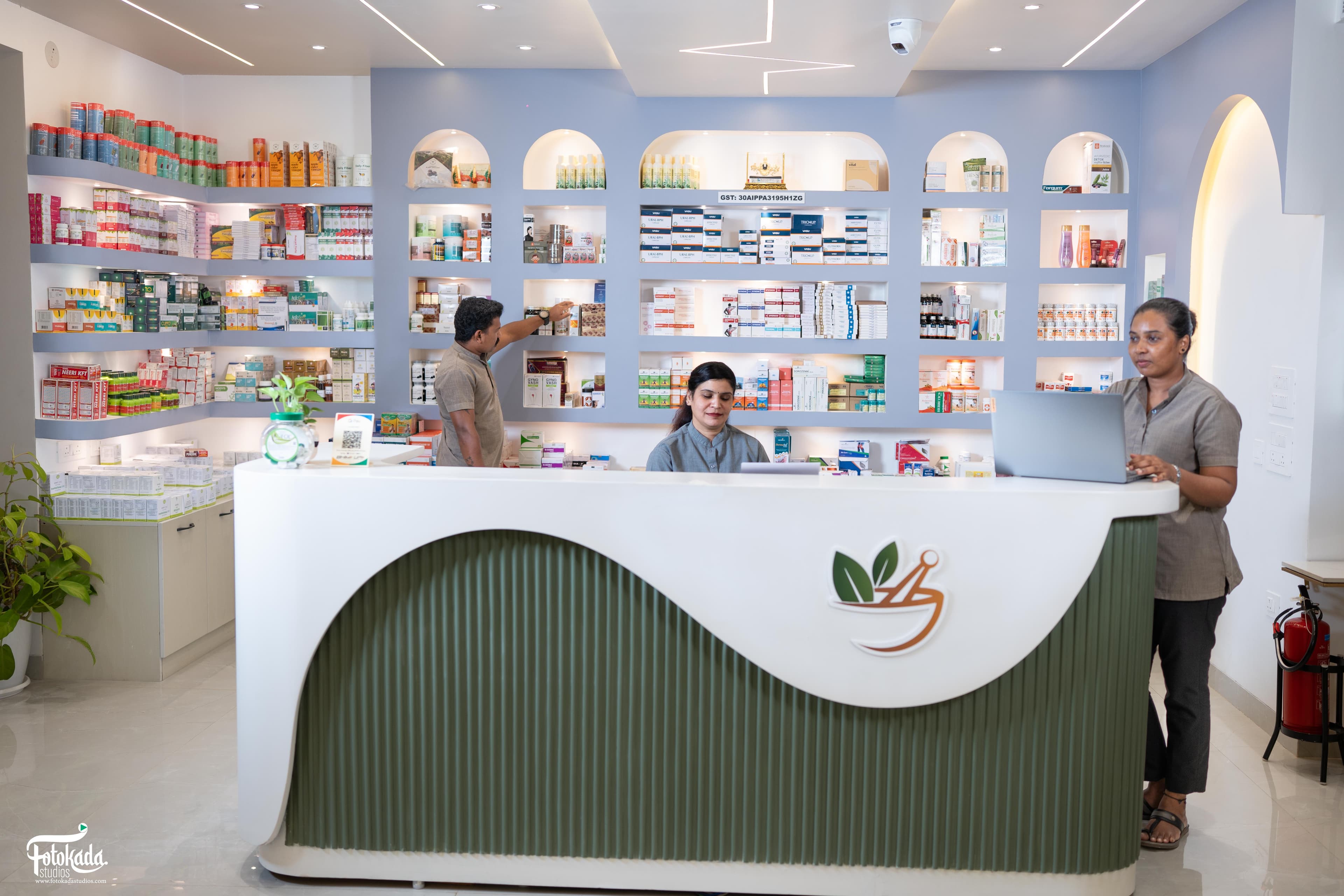 Ayurvedic pharmacy and dispensary with sage-green reception counter