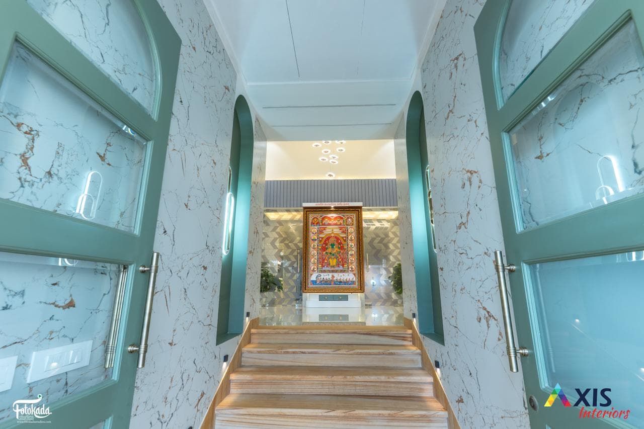 Grand lobby with patterned staircase and Ayurvedi Bhava signage